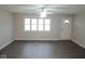 Bright living room with new flooring, a ceiling fan, and natural light from a large window at 4530 Wichser Ct, Indianapolis, IN 46228