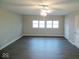 Spacious living room featuring hardwood floors, ceiling fan and natural light at 4530 Wichser Ct, Indianapolis, IN 46228