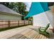 Green chair on a wooden deck and a blue sunshade, creating a relaxing atmosphere at 632 N Temple Ave, Indianapolis, IN 46201