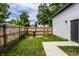 Spacious backyard with a lush green lawn and a wooden fence, perfect for outdoor activities at 632 N Temple Ave, Indianapolis, IN 46201