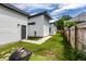 Well-maintained backyard featuring a green lawn, barbecue, and a secure wooden fence at 632 N Temple Ave, Indianapolis, IN 46201