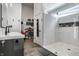 Modern bathroom featuring dual sinks, a walk-in closet, and a luxurious walk-in shower with sleek finishes at 632 N Temple Ave, Indianapolis, IN 46201