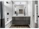 Modern bathroom featuring a double sink vanity, sleek fixtures, and a stylish shower with white tile surround at 632 N Temple Ave, Indianapolis, IN 46201