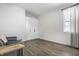 Minimalist bedroom with hardwood floors, wardrobe, sofa, and window providing natural light at 632 N Temple Ave, Indianapolis, IN 46201