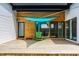 Well-lit outdoor deck with a green chair and a blue sunshade, perfect for relaxation and entertaining at 632 N Temple Ave, Indianapolis, IN 46201