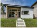 Contemporary home featuring a striking asymmetrical roofline and large windows, set against a lush green lawn at 632 N Temple Ave, Indianapolis, IN 46201