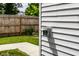 Exterior electrical outlet on the side of the home, with a wood fence and green grass in the background at 632 N Temple Ave, Indianapolis, IN 46201