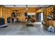 The interior of the garage is ready for storage with open stud walls and a sealed concrete floor at 632 N Temple Ave, Indianapolis, IN 46201
