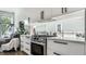 Bright kitchen features white cabinets, marble countertops, and stainless steel oven next to a large window at 632 N Temple Ave, Indianapolis, IN 46201