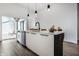 Open concept kitchen features a large center island, stainless steel appliances, and sleek modern finishes at 632 N Temple Ave, Indianapolis, IN 46201