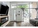 Bright living area featuring hardwood floors, electric fireplace, and multiple windows that flood the space with natural light at 632 N Temple Ave, Indianapolis, IN 46201