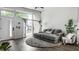 Bright living space showcasing a sectional sofa, round shag rug, and floor-to-ceiling windows with neighborhood views at 632 N Temple Ave, Indianapolis, IN 46201