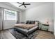 Comfortable main bedroom features a patterned rug, modern ceiling fan, and lots of natural light at 632 N Temple Ave, Indianapolis, IN 46201