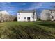 Lush backyard with green grass and patio with home exterior at 6513 Kingsbury Way, Zionsville, IN 46077