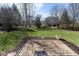Backyard featuring a patio area, trees and bushes, and green grass at 6513 Kingsbury Way, Zionsville, IN 46077