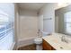Bright bathroom features a window with blinds, shower and tub, and vanity at 6513 Kingsbury Way, Zionsville, IN 46077