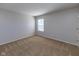 Cozy bedroom with neutral carpet, light walls, and a window for natural light at 6513 Kingsbury Way, Zionsville, IN 46077