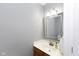 Tastefully appointed powder room features a framed mirror, neutral walls, and a stylish vanity at 6513 Kingsbury Way, Zionsville, IN 46077
