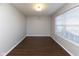 Bright room with hardwood floors, neutral walls, and natural light streaming through a window at 6513 Kingsbury Way, Zionsville, IN 46077