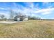 Exterior view of a large barn with a gravel driveway, providing ample storage and workspace at 725 E County Rd 600 N, Pittsboro, IN 46167