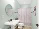 Charming powder room features a pedestal sink, elegant fixtures, and a soft color palette at 725 E County Rd 600 N, Pittsboro, IN 46167