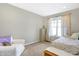 Bright bedroom with a daybed, chair, and neutral decor providing a relaxing space at 725 E County Rd 600 N, Pittsboro, IN 46167