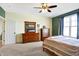 Inviting bedroom with classic wood furniture, neutral carpet, and natural light from the large window at 725 E County Rd 600 N, Pittsboro, IN 46167