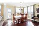 Cozy dining room with hardwood floors, abundant natural light, and stylish chandelier at 725 E County Rd 600 N, Pittsboro, IN 46167
