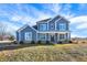Inviting two-story home featuring blue siding, classic shutters, and a well-manicured lawn at 725 E County Rd 600 N, Pittsboro, IN 46167