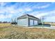 View of detached garage with 2 bays and basketball court, set against a blue sky, enhancing its curb appeal at 725 E County Rd 600 N, Pittsboro, IN 46167