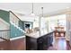 Open kitchen layout with large island, stainless appliances, and seamless flow to the living spaces at 725 E County Rd 600 N, Pittsboro, IN 46167