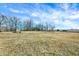 Expansive yard with bare trees in the background and a clear blue sky, offering plenty of open space and privacy at 725 E County Rd 600 N, Pittsboro, IN 46167