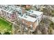 An aerial view of modern, multi-story townhouses with brick and gray siding under a bright sky, showcasing urban living at 805 Switchyard Pl, Indianapolis, IN 46202