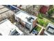 Drone view of modern townhomes showing private balconies, stylish exteriors, manicured landscaping, and parking spaces at 805 Switchyard Pl, Indianapolis, IN 46202