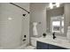 Modern bathroom with tub, tile surround, modern fixtures and decorative vanity at 805 Switchyard Pl, Indianapolis, IN 46202