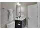 Bathroom with black vanity, white countertop, and large mirror provides a modern look at 805 Switchyard Pl, Indianapolis, IN 46202