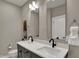 Bathroom featuring a double vanity, modern fixtures, and contemporary design at 805 Switchyard Pl, Indianapolis, IN 46202