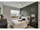 Comfortable bedroom featuring a queen-sized bed, modern decor, and a large window at 805 Switchyard Pl, Indianapolis, IN 46202