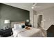 Cozy bedroom with a queen bed, side tables, and a view into the hallway at 805 Switchyard Pl, Indianapolis, IN 46202