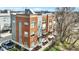 Brick and gray sided townhomes show modern architectural details, complemented by a manicured lawn and paved driveway at 805 Switchyard Pl, Indianapolis, IN 46202