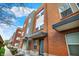 This streetscape showcases the architectural variety of townhomes, blending brickwork and siding for visual appeal at 805 Switchyard Pl, Indianapolis, IN 46202