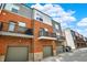 Modern townhome complex featuring red brick facade, balconies, and convenient garage access at 805 Switchyard Pl, Indianapolis, IN 46202