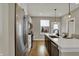 Bright kitchen featuring a large island with seating, stainless steel appliances, and stylish pendant lighting at 805 Switchyard Pl, Indianapolis, IN 46202