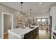 Open concept kitchen with a view into the living room, featuring a large island and modern finishes at 805 Switchyard Pl, Indianapolis, IN 46202