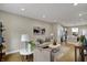 Open-concept living room featuring modern furnishings, bright lighting, and seamless flow to the kitchen at 805 Switchyard Pl, Indianapolis, IN 46202