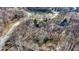 Aerial view of homes nestled among trees with ponds and winding roads at 8220 Traders Hollow Ct, Indianapolis, IN 46278