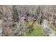 Aerial view of a brick home with a circular driveway and tree-lined lot at 8220 Traders Hollow Ct, Indianapolis, IN 46278