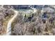 Aerial view of homes nestled among trees with ponds and winding roads at 8220 Traders Hollow Ct, Indianapolis, IN 46278