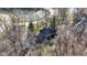 Aerial view of home near a pond and surrounded by many tall trees in a quiet area at 8220 Traders Hollow Ct, Indianapolis, IN 46278
