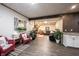 View of a finished basement space with a seating area, a bar with sink, and large windows at 8220 Traders Hollow Ct, Indianapolis, IN 46278